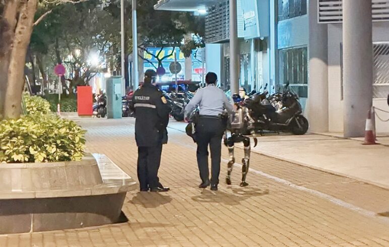 humanoid robot escorted away